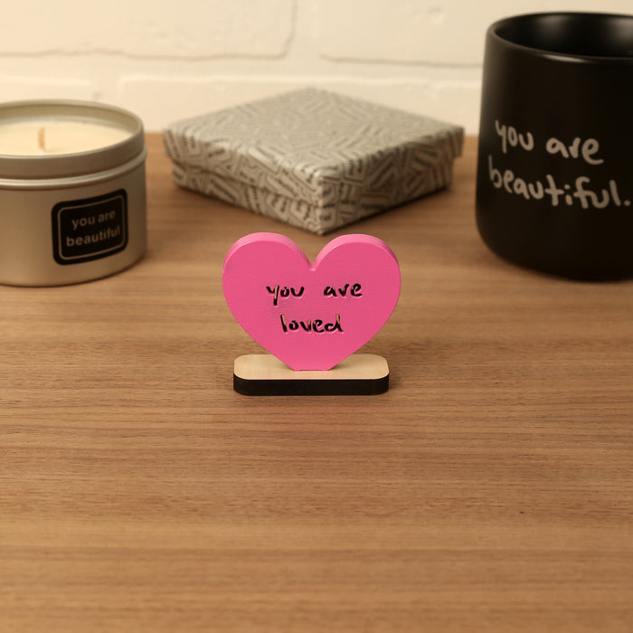 Heart-shaped Valentine mini sculpture with the phrase “you are loved,” styled as a small desk or shelf gift.