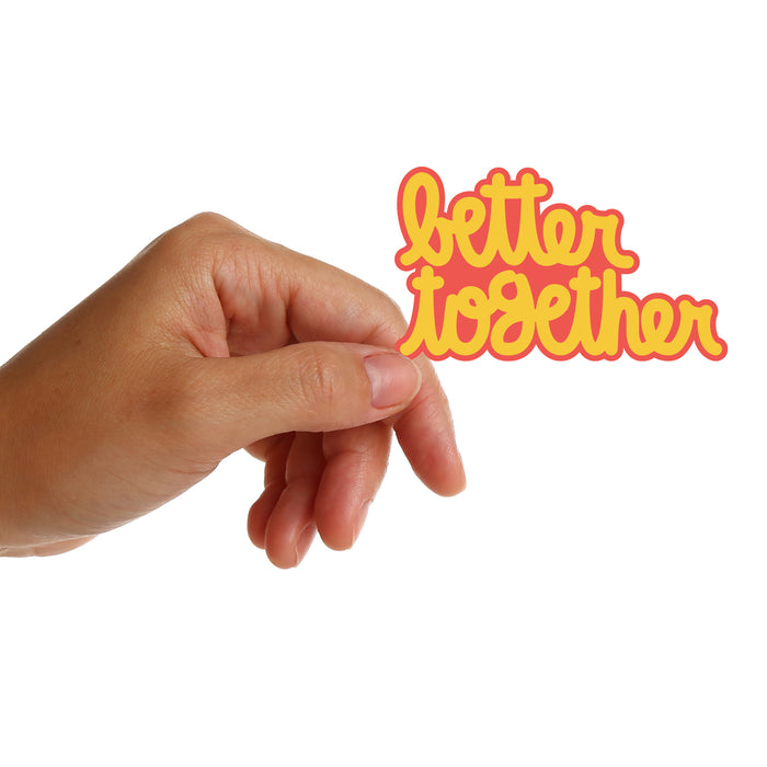 Hand reaching towards 'better together' sticker by Matthew Hoffman on a white background