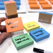 Colorful sticky notes with motivational phrases on a white surface.